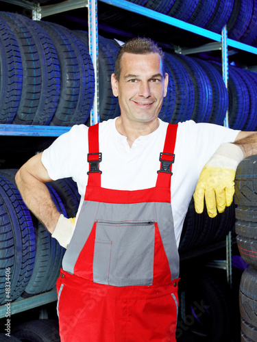 Photo: Motormechanic in a garage is satisfied with his job Motormechanic in a garage is satisfied with his job