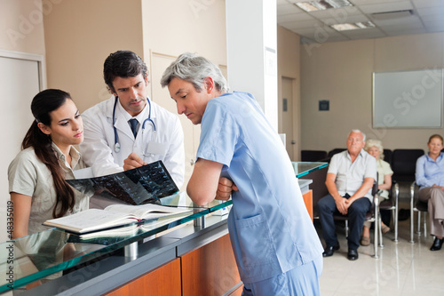 Photo: Doctors Reviewing X-ray At Reception Doctors Reviewing X-ray At Reception