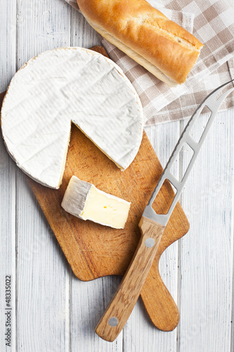 Photo: camembert cheese on kitchen table camembert cheese on kitchen table