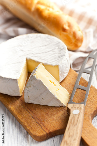 Photo: camembert cheese on kitchen table camembert cheese on kitchen table
