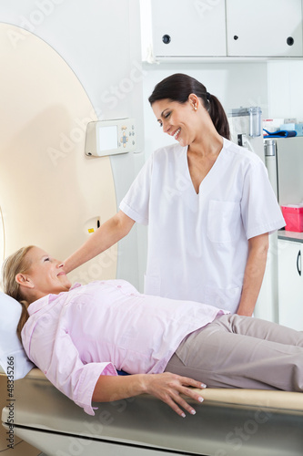 Photo: Radiologic Technician Looking At Patient Radiologic Technician Looking At Patient