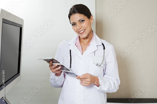 Photo: Female Radiologist Holding Sonography Print Female Radiologist Holding Sonography Print