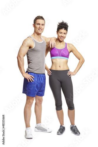 Photo: Young man and woman relaxing in sports outfits Young man and woman relaxing in sports outfits