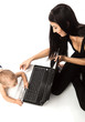 Young beautiful woman and her little son playing with laptop