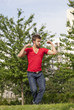Foto: young man buffing up his muscles with humor young man buffing up his muscles with humor