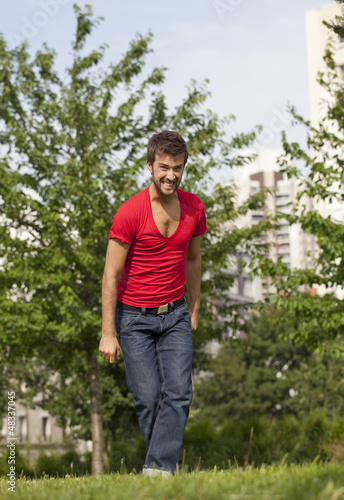 Photo: irritated young man destressing outdoors irritated young man destressing outdoors