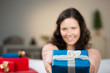 Photo: lächelnde frau überreicht ein weihnachtsgeschenk lächelnde frau überreicht ein weihnachtsgeschenk