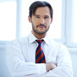 Handsome man standing with folded arms