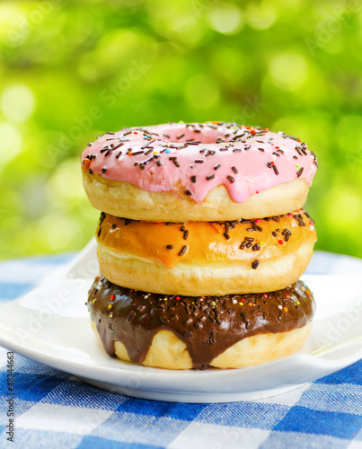 Photo: Fresh donuts on nature background Fresh donuts on nature background