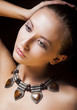 Adorable Woman with Metallic Necklace and Amber. Natural Makeup