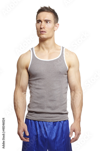 Photo: Muscular young man in sports outfit Muscular young man in sports outfit