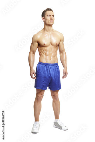 Photo: Muscular young man in sports outfit Muscular young man in sports outfit