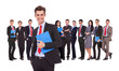 Leader holding a clipboard with business team behind