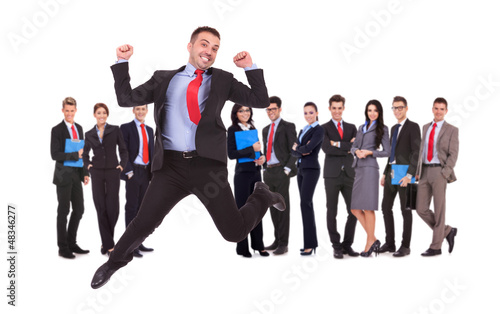 Photo: business man jumping in front of his business team business man jumping in front of his business team