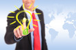 smiling business man pushing a light bulb button