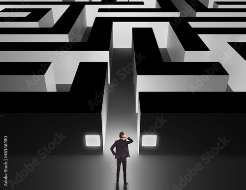 Photo: Businessman in front of a huge maze Businessman in front of a huge maze