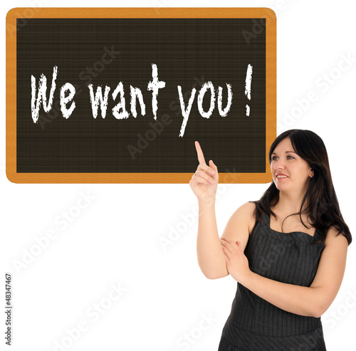 Photo: Business Woman pointing up to a sign Business Woman pointing up to a sign