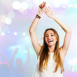 Young woman dancing with party background.
