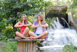 Two teen girls sitting in yoga position