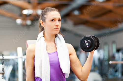 Photo: Woman working out in a fitness club Woman working out in a fitness club