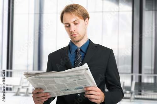 Photo: Businessman reading a newspaper Businessman reading a newspaper