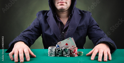 Photo: Poker player on black background Poker player on black background