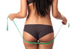 Photo: Rear view of a beautiful young woman holding a measure tape Rear view of a beautiful young woman holding a measure tape