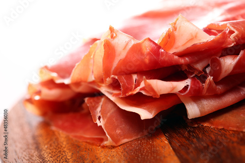 Photo: Proscuitto on a wooden plate Proscuitto on a wooden plate