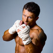 Close-up portrait of a kick-boxer in a fighting stance.