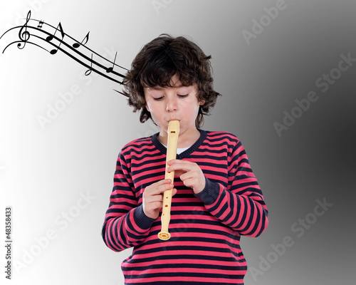 Photo: Adorable child playing flute Adorable child playing flute