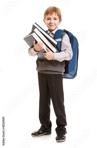 Photo: Schoolboy with backpack holding books Schoolboy with backpack holding books