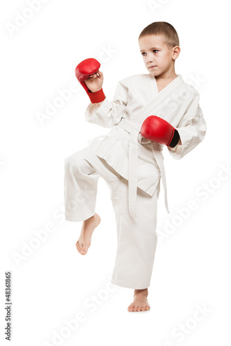 Photo: Child boy in kimono training karate Child boy in kimono training karate