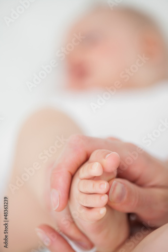 Photo: Feet of a baby being touched Feet of a baby being touched