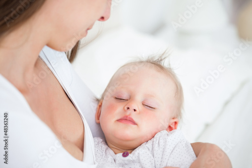 Photo: Baby falling asleep in the arms of her mother Baby falling asleep in the arms of her mother