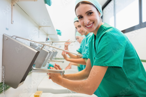 Photo: Surgeons washing their hands while smiling Surgeons washing their hands while smiling