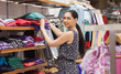 Photo: Woman putting jumpers on shelf Woman putting jumpers on shelf