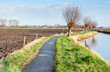 Narrow bike path besides a meandering river.