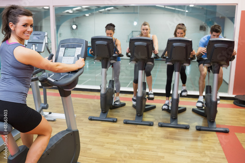 Photo: Smiling woman teaching spinning class Smiling woman teaching spinning class