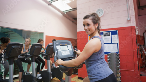 Photo: Happy woman teaches spinning class Happy woman teaches spinning class
