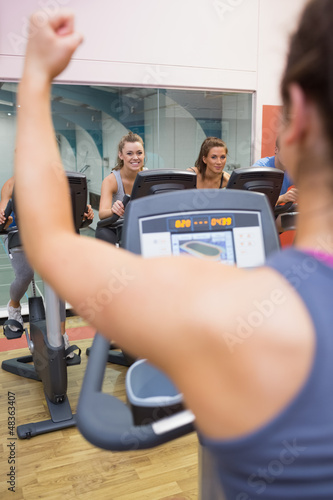 Photo: Motivational female instructor teaches spinning class Motivational female instructor teaches spinning class