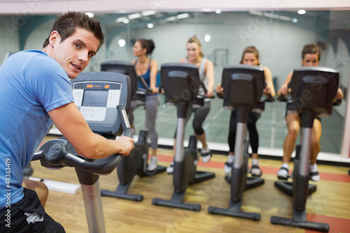 Photo: Male instructor at spinning class Male instructor at spinning class