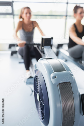 Photo: Rowing machine being used in gym Rowing machine being used in gym