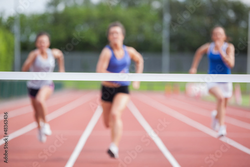Photo: Athletes racing towards finish line Athletes racing towards finish line