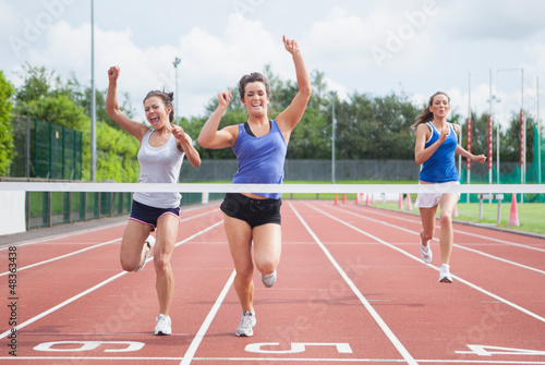 Photo: Athletes celebrating as they cross finish line Athletes celebrating as they cross finish line