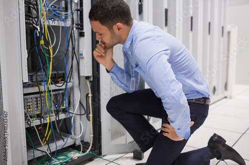 Photo: Technican checking server Technican checking server