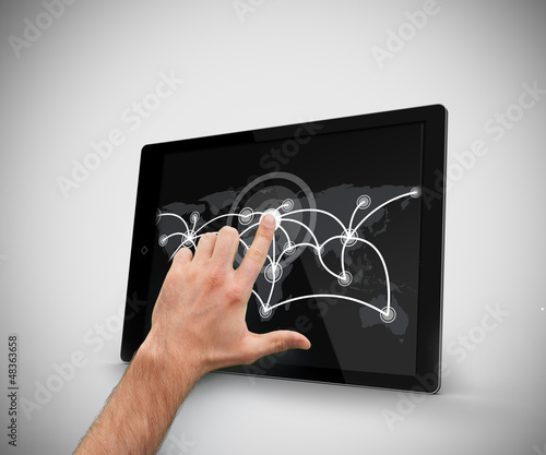 Photo: Hand touching at tablet pc Hand touching at tablet pc