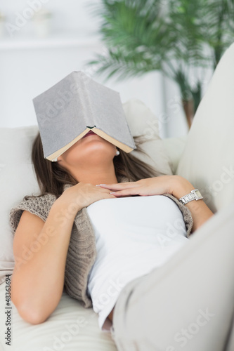 Photo: Brunette sleeping with her book on the head Brunette sleeping with her book on the head
