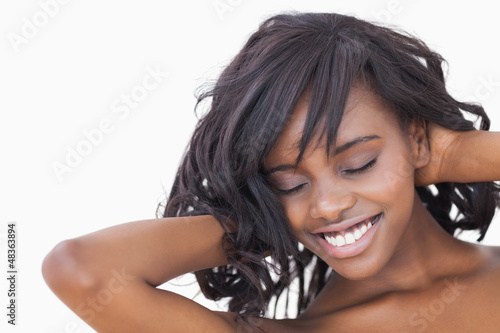 Photo: Woman ruffling her hair Woman ruffling her hair