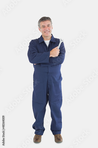 Photo: Portrait of mature mechanic with wrench Portrait of mature mechanic with wrench