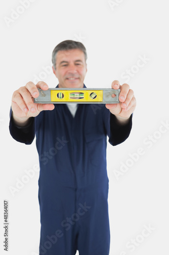 Photo: Technician with spirit level Technician with spirit level